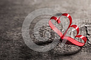Two ribbon hearts on wood