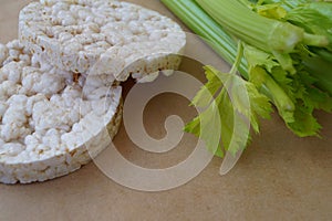 Two rice white round bread with fresh green stem celery healthy food organic product