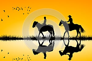 Two riders on horses standing together on sunset