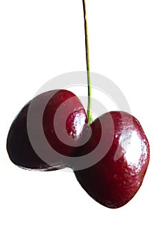 Two ripe accrete berries of a sweet cherry on a white background