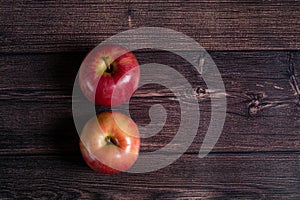 two ripe apples on a brown wooden background.top view.