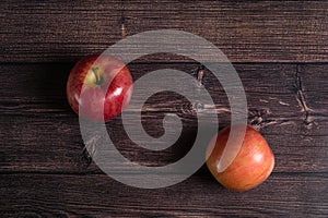 two ripe apples on a brown wooden background.top view.