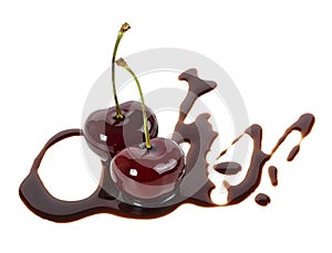 Two ripe cherries in liquid chocolate on white background