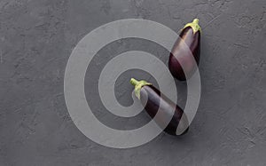 Two ripe Eggplants on grey background. Concept of healthy vegan food. Copy space. Top view