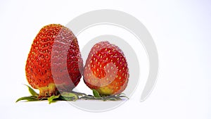 Two ripe juicy red strawberries on a white background.