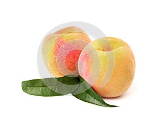 Two ripe peach with leaves