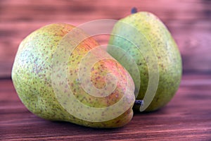 Two ripe pears on an old wooden table.
