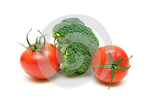 Two ripe tomatoes and broccoli on white background