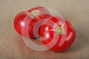 Two ripe tomatos on a parchment