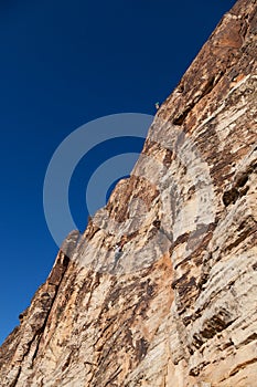 Two Rock Climbers High on a Cliff