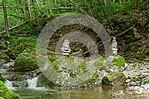 Two rock stacks in a streambed, piles of stacked rocks