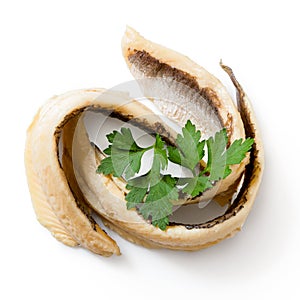 Two rolled anchovy fillets with flat leaf parsley isolated on white from above