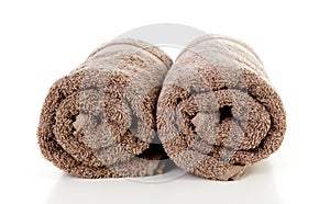 Two rolled brown towels