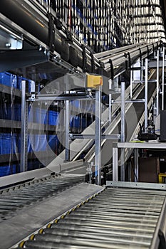 Two roller conveyors in an automated warehouse.