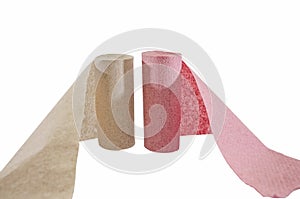 Two rolls of pink and gray toilet paper isolated on white background