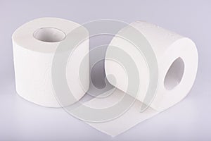 Two rolls of white toilet paper isolated. The paper product used in the sanitary and hygienic purposes