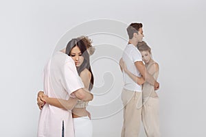 Two romantic couples in love indoors against white photo