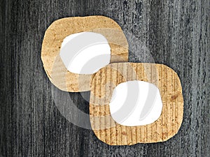 Two round blank cardboard frames on painted background