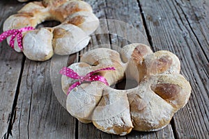 Two round bread wreath of rye flour tied with ribbon, gift