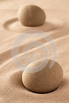 Two round stones in sand