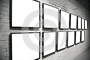 Two rows frames on brick white wall