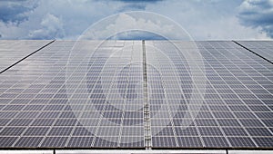 Two rows of a mega photovoltaic facility with over two megawatt on a roof of a very huge hall photo