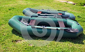 Two rubber inflatable boats on grass