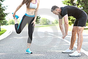 Two runners sprinting outdoors - Sportive people training in a