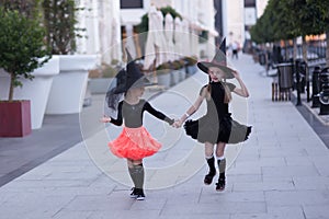 Two running girls fairies in carnival costumes.