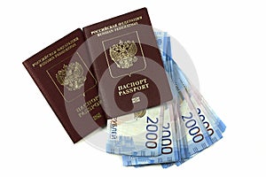 Two Russian passports with bills two thousand rubles on a white background. Traveling abroad, package trip, family