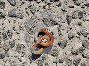Two rusty chain links on stones