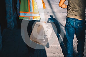 Two sad men walking with empty can of diesel fuel in the street