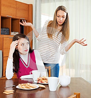 Two sad women having conflict