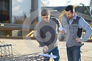 Two safety specialists monitoring perimeter petrochemical refinary