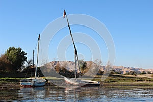 Two  sail  boats lying on the river shore in Luxor