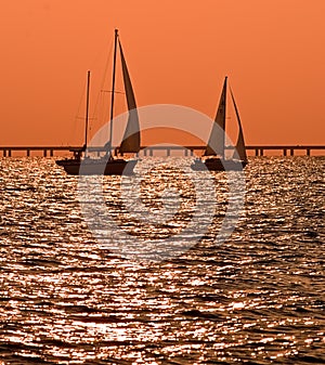 Two sailboats at dusk