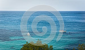 Two Sailing boat on blue mediterranean water in Ibiza island