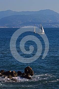 Two of sailing boats floating on the sea against the background