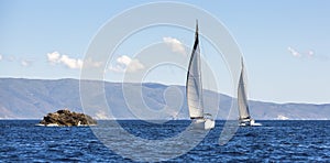 Two sailing boats yacht or sail regatta race on blue water Sea. Sport.