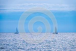 Two Sailing yachts in the blue calm sea