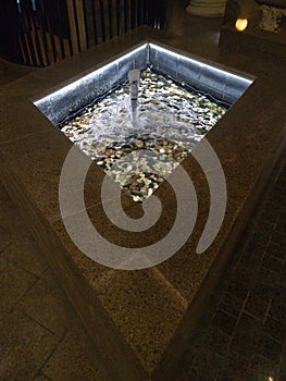 Water fountain with gobble stones of different colors photo