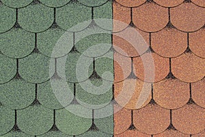 Two samples of joined bituminous coating for rooftop with pattern in form of scaly tiles of brown and green with black outline.