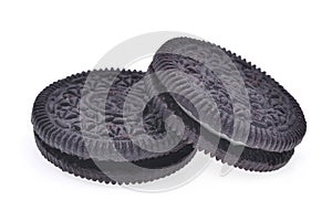 Two sandwich chocolate cookies with cream isolated on white back