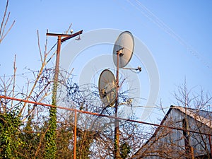 Two satellite dishes on a pole in the village. Antennas for TV