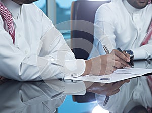 Two Saudi Businessmen Hands Signing A Ducument