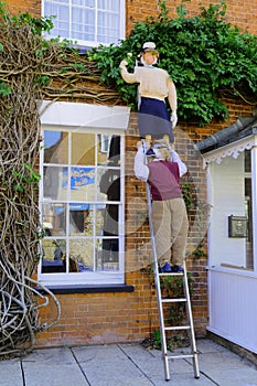 Two scarecrows standing on the ladder