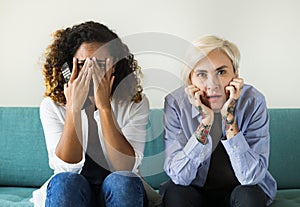 Two scared girls on the couch