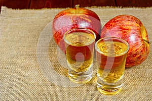 Two schnapps drinks and red apples