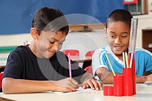 Two school boys enjoying their learning in class