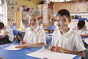 Two schoolboys in a primary school class, looking to camera photo